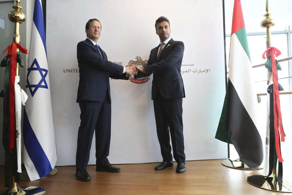 Israel's President Isaac Herzog, left, shakes hands with United Arab Emirates ambassador to Israel Mohamed Al Khaja during the opening ceremony for the new UAE Embassy in Tel Aviv, Israel, Wednesday, July 14, 2021. (AP Photo/Ariel Schalit)