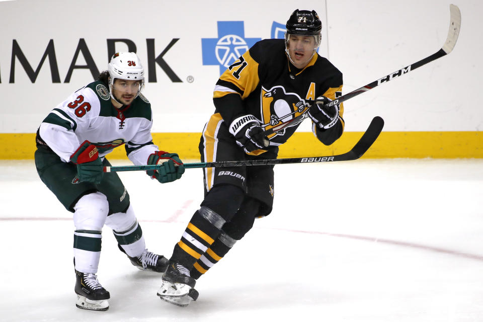 Pittsburgh Penguins' Evgeni Malkin (71) is defended by Minnesota Wild's Mats Zuccarello (36) during the first period of an NHL hockey game in Pittsburgh, Tuesday, Jan. 14, 2020. (AP Photo/Gene J. Puskar)