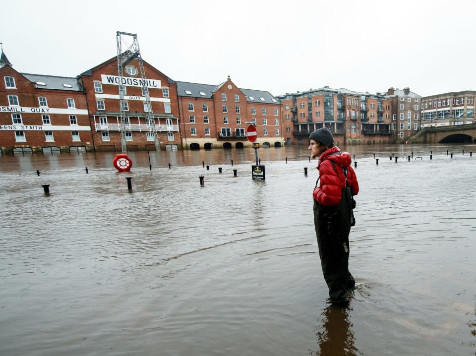 A person stands in flood water in York as Storm Christoph is set to bring widespread flooding, gales and snow to parts of the UK.  (Danny Lawson/PA)