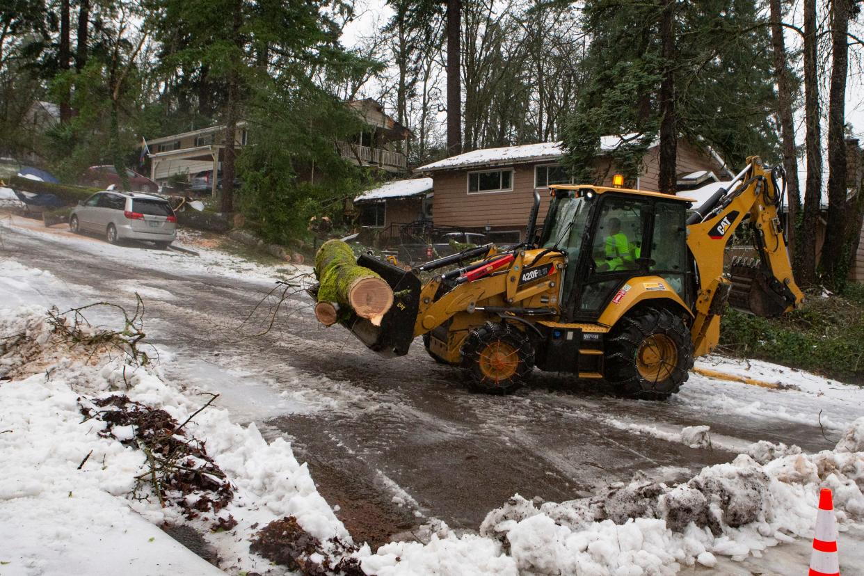 City crews clear a fallen tree from Madison Street during a winter storm Jan. 17 in Eugene.