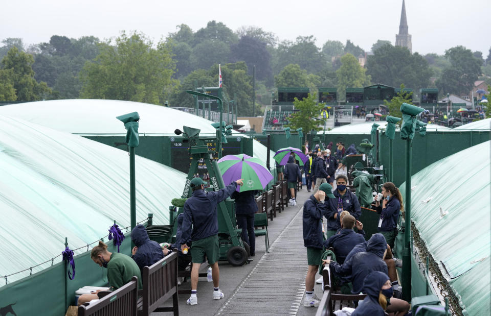 The outside courts are covered during a rain delay on day one of the Wimbledon Tennis Championships in London, Monday June 28, 2021. (AP Photo/Kirsty Wigglesworth)