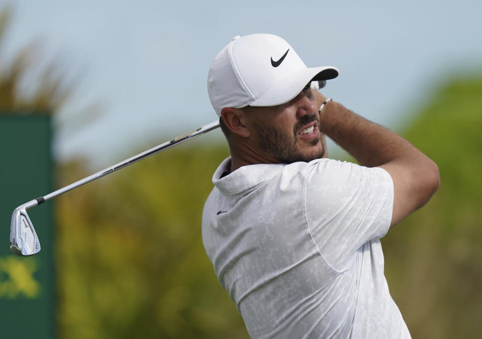 Brooks Koepka, of the United States, watches his shot on the second tee during day three of the Hero World Challenge PGA Tour at the Albany Golf Club, in New Providence, Bahamas, Saturday, Dec. 4, 2021. (AP Photo/Fernando Llano)