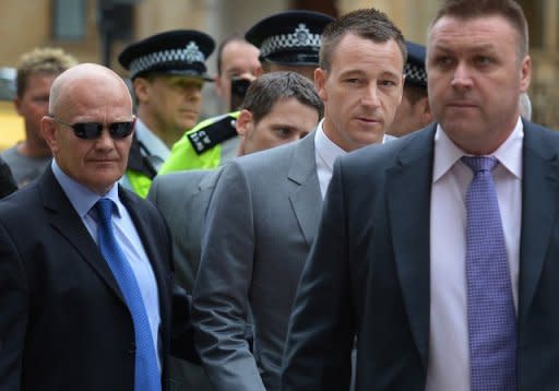 Chelsea and England footballer John Terry (2nd R) arrives at Westminster Magistrates court in London. Terry racially abused rival footballer Anton Ferdinand in response to taunts about his alleged affair with a teammate's girlfriend, a court heard Monday