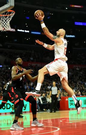 Dec 11, 2018; Los Angeles, CA, USA; LA Clippers center Marcin Gortat (13) drives to the basket as Toronto Raptors forward Serge Ibaka (9) looks on during the first half at Staples Center. Mandatory Credit: Kirby Lee-USA TODAY Sports