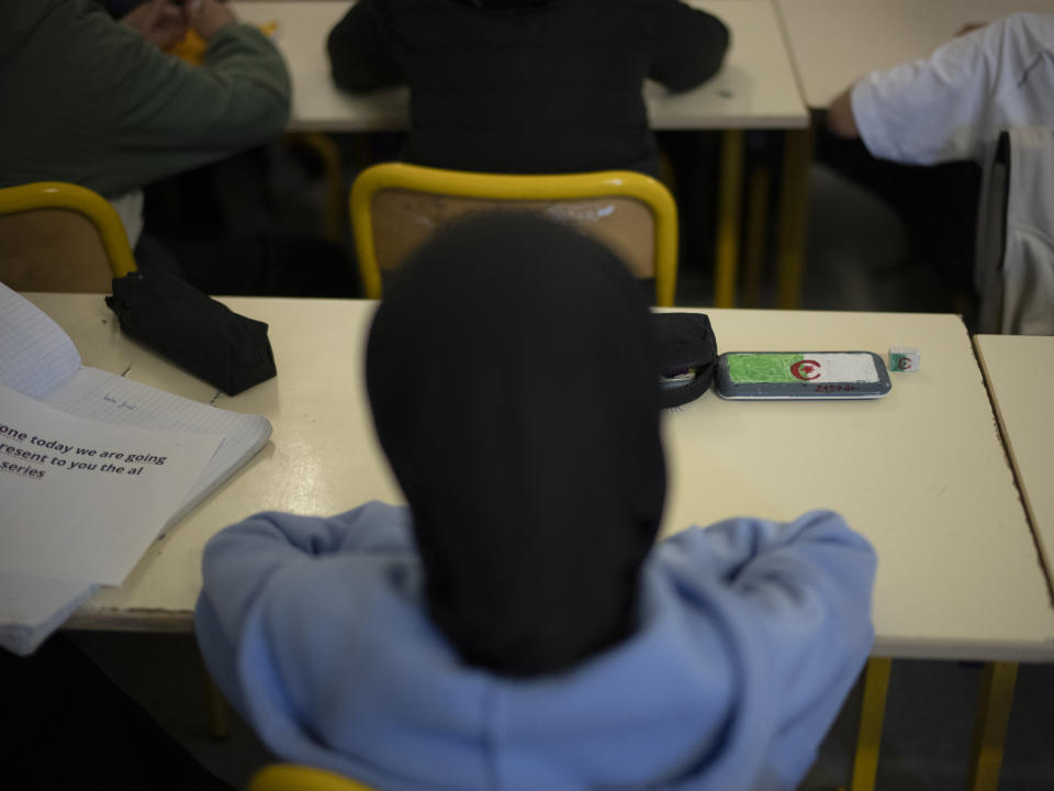 A pencil case decorated with the Algerian flag sits on a student's desk at Ibn Khaldoun, a private Muslim school, in Marseille, southern France, Thursday, April 18, 2024. (AP Photo/Daniel Cole)