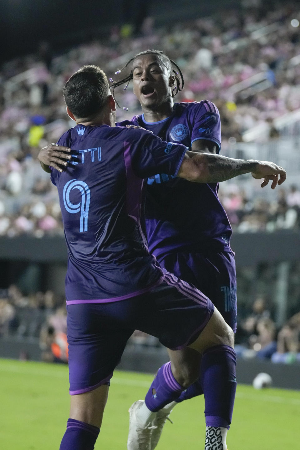 Charlotte FC forward Enzo Copetti (9) celebrates with Charlotte FC forward Kerwin Vargas (18) after Copetti scored his side's first goal against Inter Miami during the first half of an MLS soccer match, Wednesday, Oct. 18, 2023, in Fort Lauderdale, Fla. (AP Photo/Rebecca Blackwell)