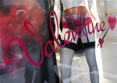 Men are reflected in a shop window of a lingerie store on the eve of St Valentine's Day in Frankfurt February 13, 2013. REUTERS/Lisi Niesner