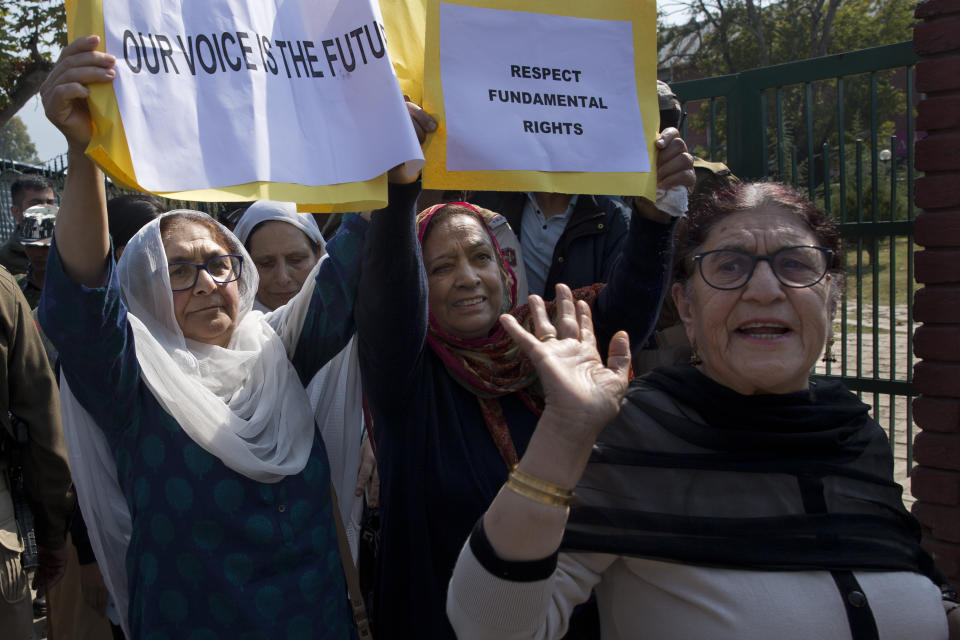 A small group of women under the banner of ‘Women of Kashmir’, hold placards during a peaceful protest in Srinagar, Indian controlled Kashmir, Tuesday, Oct. 15, 2019. Police detained members of the group which had gathered to condemn Indian government downgrading the region's semi-autonomy and demanded restoration of civil liberties and fundamental rights of citizens. (AP Photo/Dar Yasin)