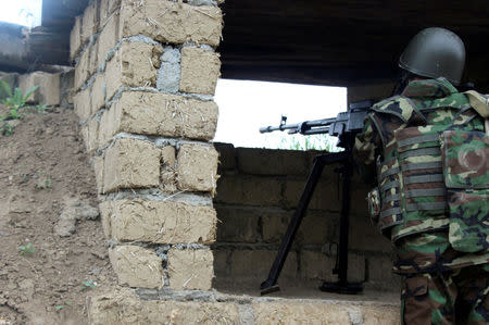 An Azeri serviceman aims his weapon at the frontline with the self-defense army of Nagorno-Karabakh in Azerbaijan, April 29, 2016. REUTERS/Zulfiya Safkhanova/File Photo