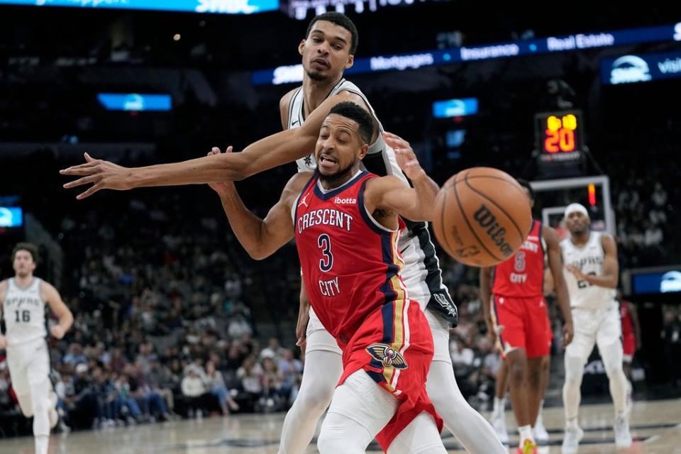 San Antonio Spurs center Victor Wembanyama (1) knocks the ball away from New Orleans Pelicans guard CJ McCollum (3) in San Antonio on Dec. 17.