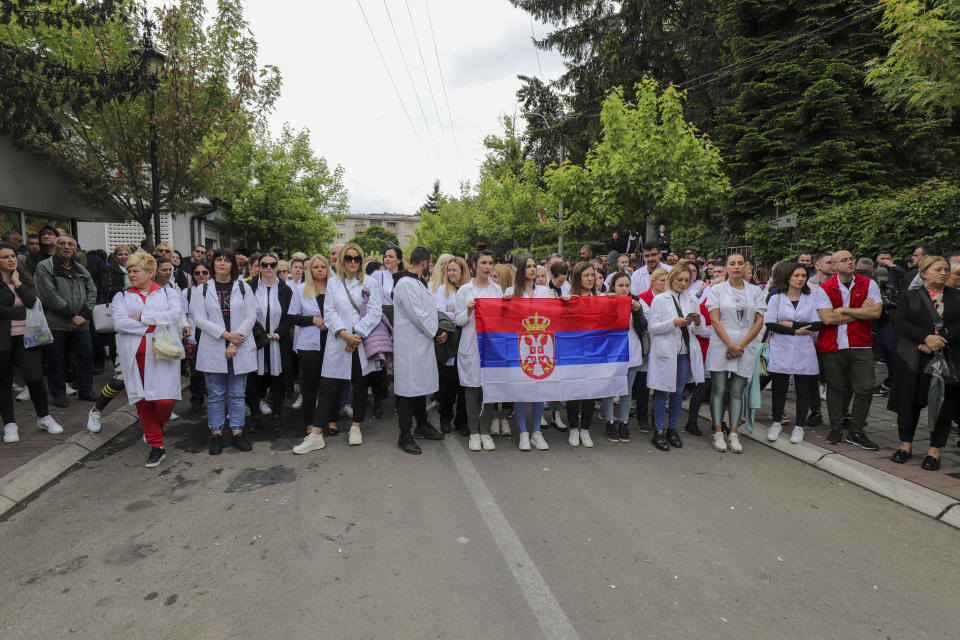 People attend a protest rally in front of the city hall in the town of Zvecan, northern Kosovo, Wednesday, May 31, 2023. Hundreds of ethnic Serbs began gathering in front of the city hall in their repeated efforts to take over the offices of one of the municipalities where ethnic Albanian mayors took up their posts last week. (AP Photo/Bojan Slavkovic)