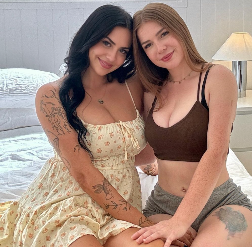 Ruby Drew and another woman posing on bed 