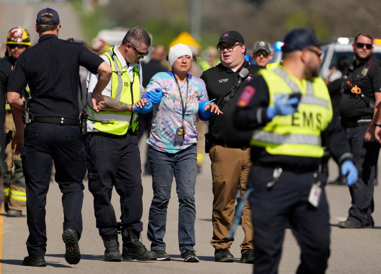 A woman is transported from a fatal school bus crash on SH 21 near Caldwell Road Friday March 22, 2024.