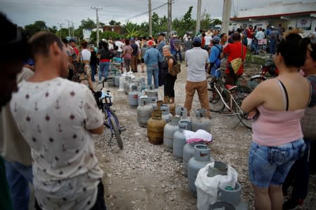 People wait in line to buy cooking gas in Jesus Menendez, Cuba