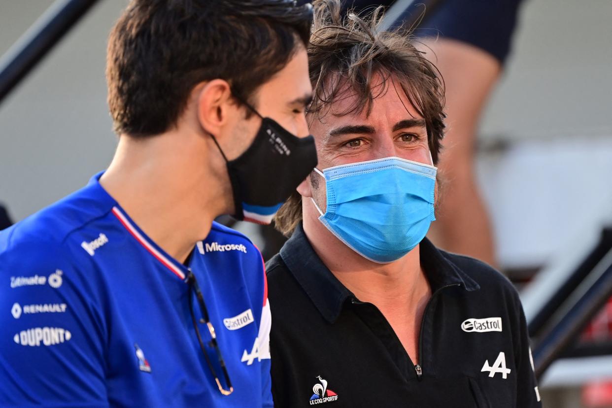 Alpine's French driver Esteban Ocon (L) and Alpine's Spanish driver Fernando Alonso chat during the drivers parade ahead of the Qatari Formula One Grand Prix at the Losail International Circuit, on the outskirts of the capital city of Doha, on November 21, 2021. (Photo by ANDREJ ISAKOVIC / AFP) (Photo by ANDREJ ISAKOVIC/AFP via Getty Images)