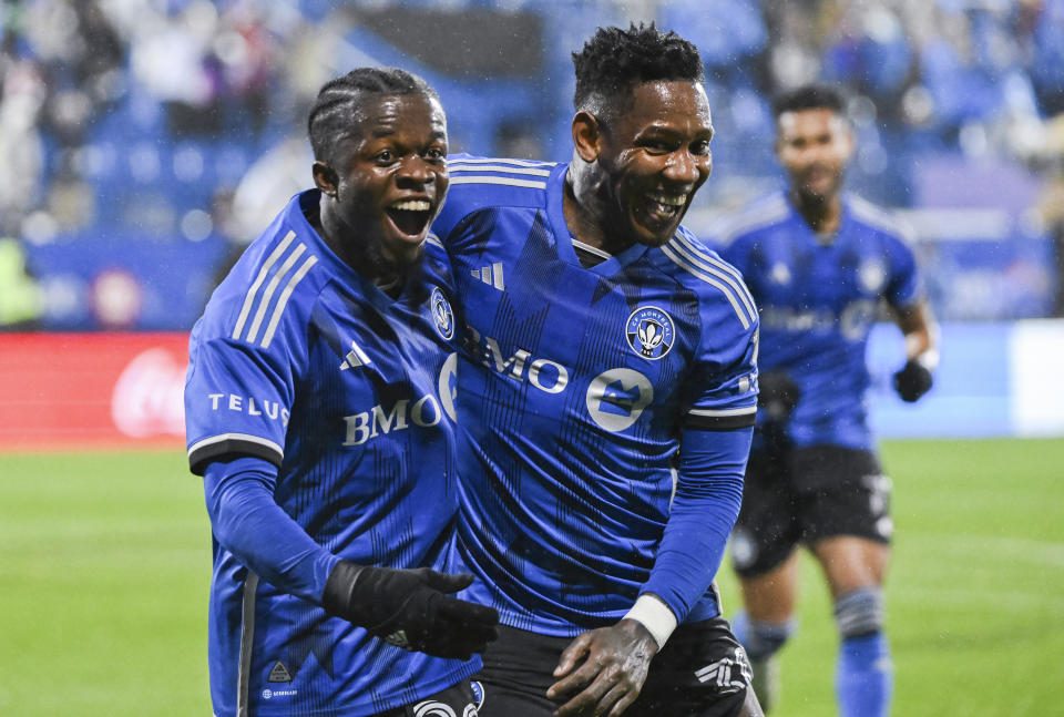 CF Montreal's Kwadwo Opoku, left, celebrates with teammate Romell Quioto after scoring against the Portland Timbers during the first half of an MLS soccer game in Montreal, Saturday, Oct. 7, 2023. (Graham Hughes/The Canadian Press via AP)