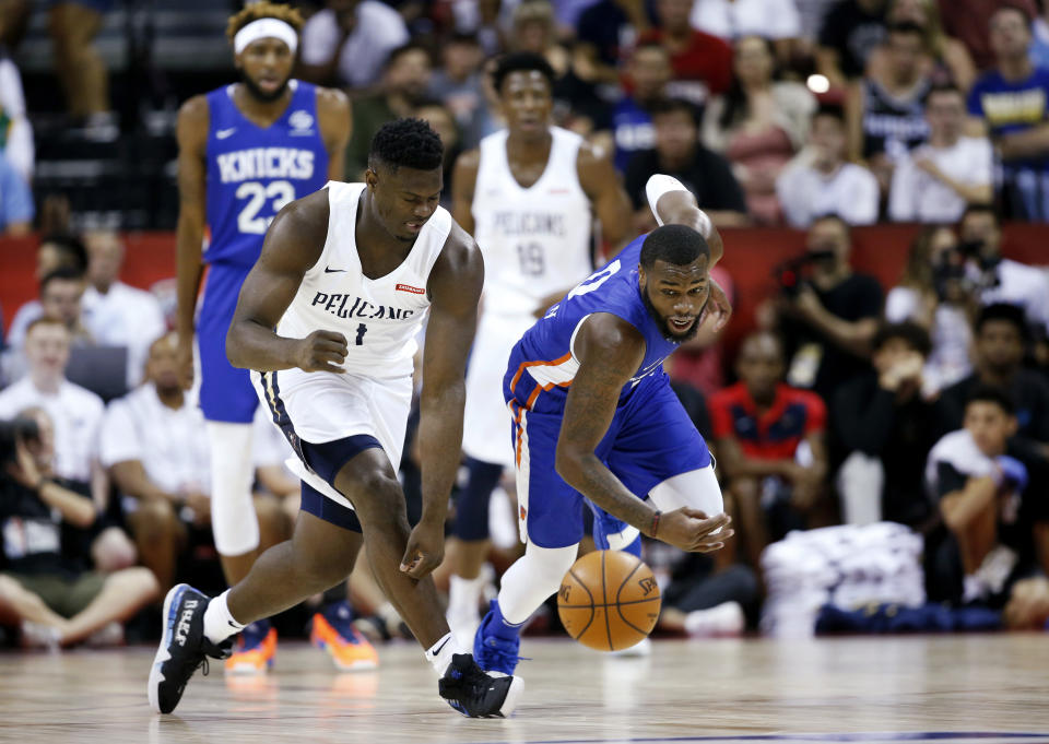 New Orleans Pelicans' Zion Williamson, left, and New York Knicks' Kadeem Allen chase the ball during an NBA summer league basketball game Friday, July 5, 2019, in Las Vegas. (AP Photo/Steve Marcus)
