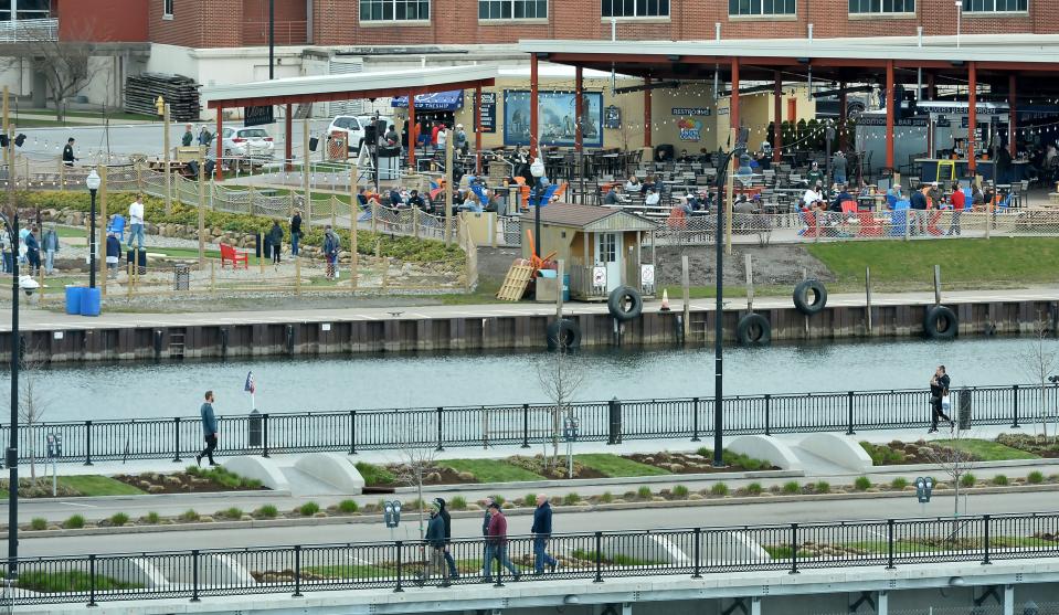 Pedestrians begin to make their way along lower State Street in Erie on April 8, 2024. Many tourists are in town to view the solar eclipse.