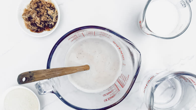 rice water, milk, and sugar in measuring cup