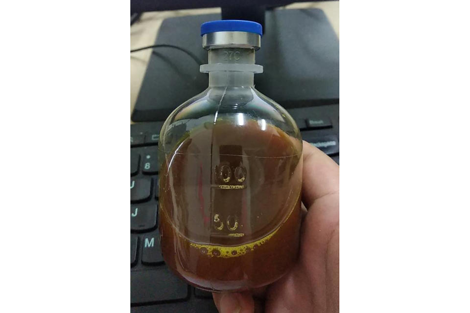 This August 2020, photo provided by a Uighur under quarantine shows a bottle of unidentified traditional Chinese medicine in Urumqi, China. As parts of the Xinjiang region in China's far northwest enters the 45th day of a second grueling lockdown due to a coronavirus outbreak, the government there is coercing some residents into using traditional Chinese medicine despite a lack of rigorous clinical data proving it works. (AP Photo)