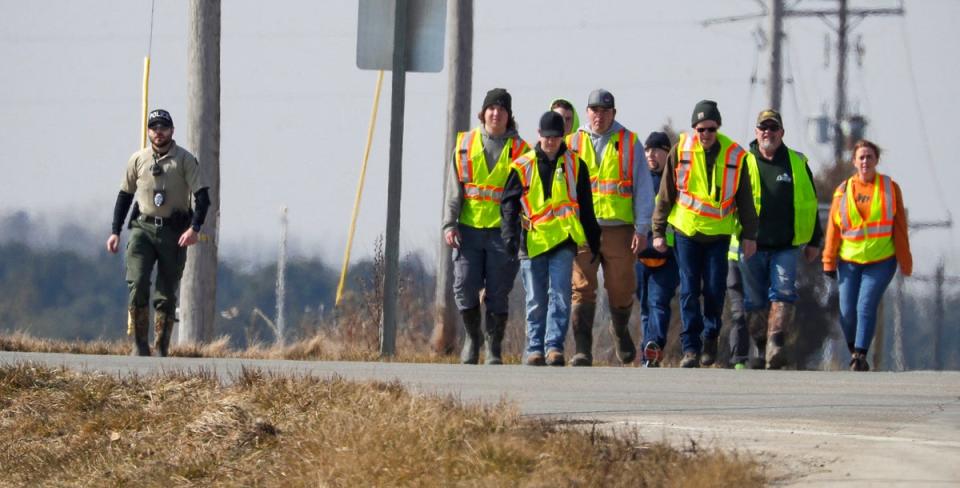 Police and area firefighters walk along state Highway 310 near Johnston Road during the search for missing three-year-old Elijah Vue on Tuesday 27 February (USA Today-Wisconsin 2024, copyright, all rights reserved)