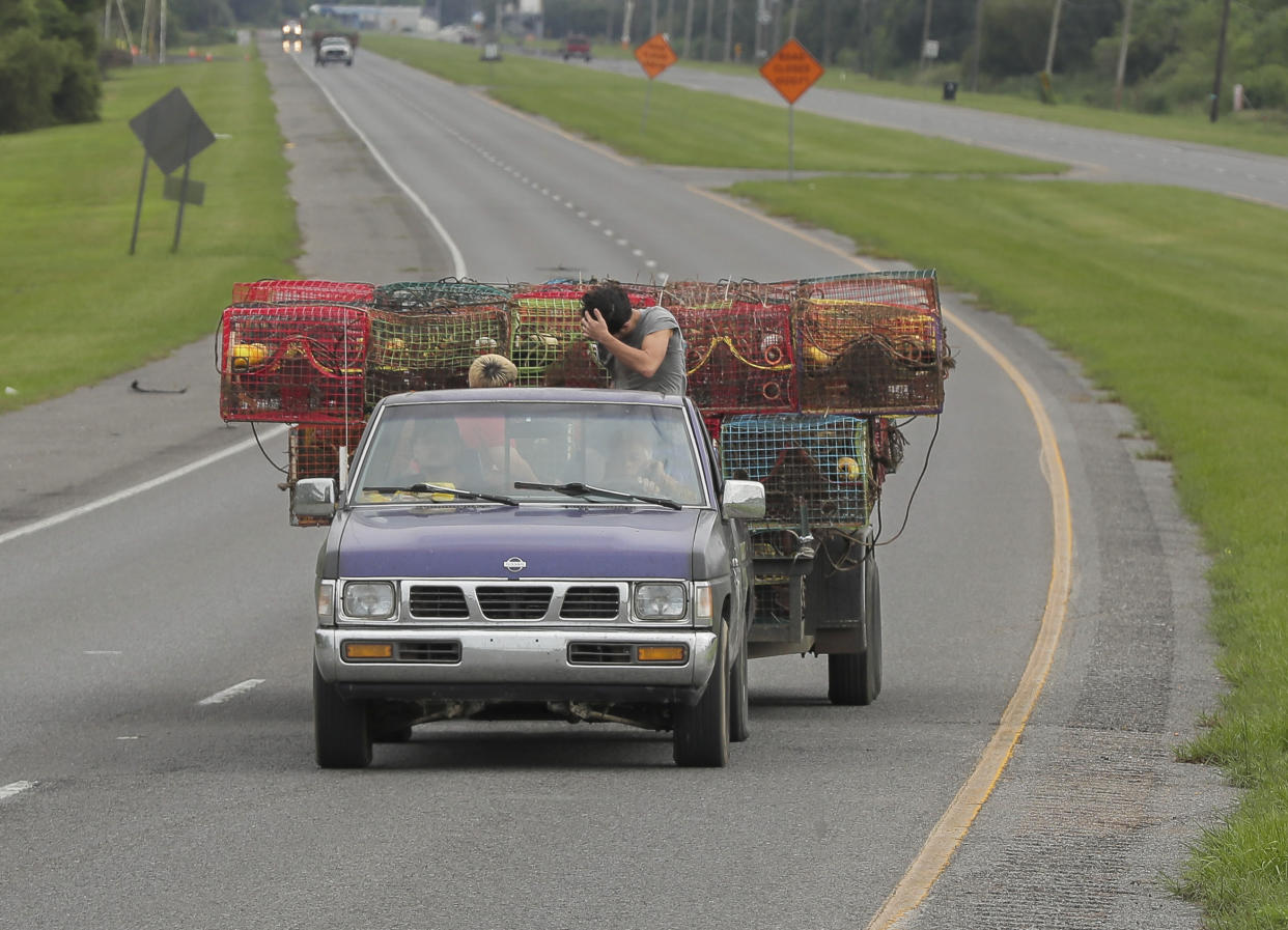 Crabbers move their traps to inside the levy protection system ahead of Tropical Storm Francine, Monday, Sept. 9, 2024, in lower St. Bernard Parish, La. (David Grunfeld/The Times-Picayune/The New Orleans Advocate via AP)