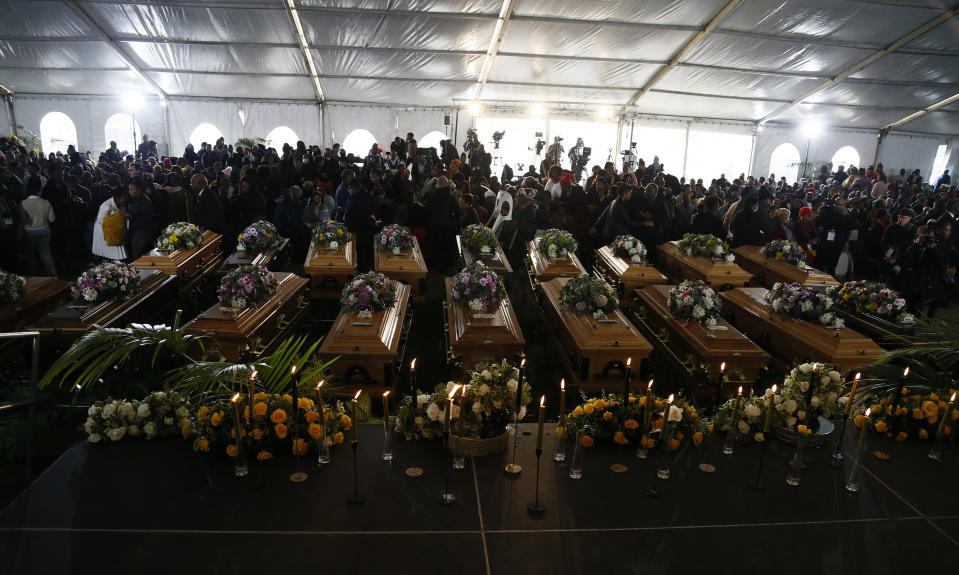 A view of the coffins during a funeral service held in Scenery Park, East London, South Africa, Wednesday, July 6, 2022. More than a thousand grieving family and community members are attending the funeral in South Africa's East London for 21 teenagers who died in a mysterious tragedy at a nightclub nearly two weeks ago. South African President Cyril Ramaphosa is due to give the eulogy for the young who died. (AP Photo)