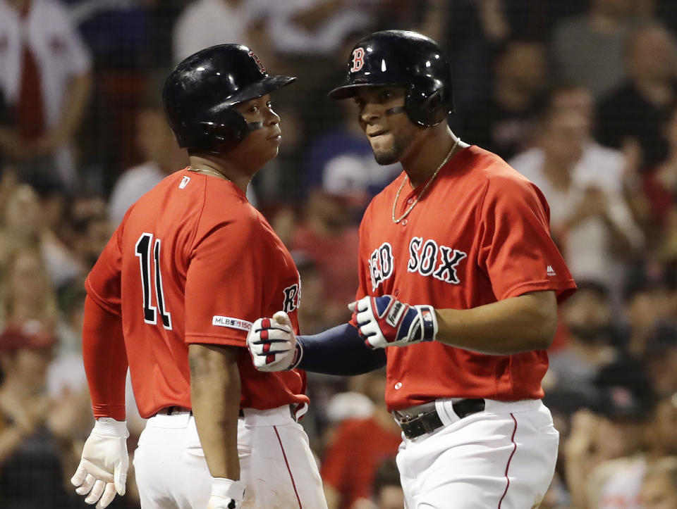 Boston Red Sox's Xander Bogaerts, right, celebrates his three-run home run with Rafael Devers during the seventh inning of the team's baseball game against the Los Angeles Dodgers at Fenway Park, Friday, July 12, 2019, in Boston. (AP Photo/Elise Amendola)