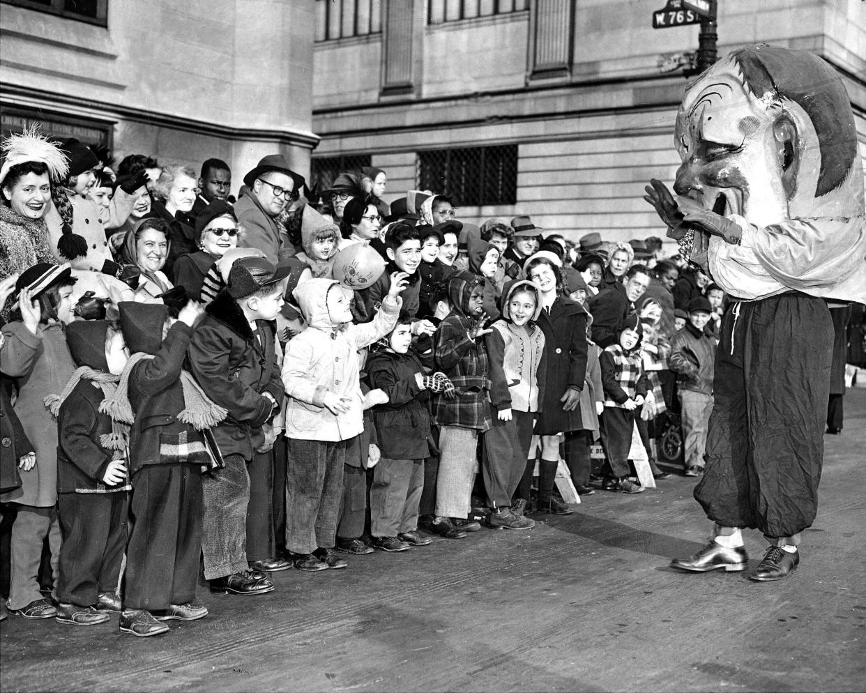 A clown greeting kids along Central Park West