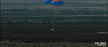 Blue Origin's New Shepard space capsule floats back to Earth under parachutes after a successful unmanned suborbital test flight from the company's West Texas facility on Nov. 23, 2015.