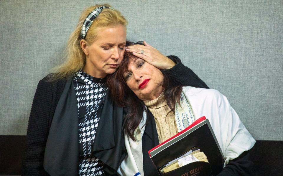 Cindy Falco DiCorrado, found guilty of refusing to wear a mask at a Boca Raton-area bagel shop and then resisting arrest for trespassing, is hugged by a supporter before her sentencing hearing Monday, February 28, 2022.  