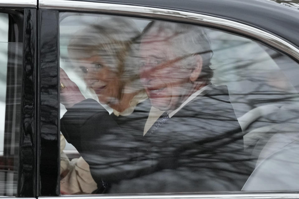 FILE - Britain's King Charles III waves as he and Queen Camilla leave Clarence House by car in London, Tuesday, Feb. 6, 2024. When it comes to the United Kingdom's royal family, the Americans can't seem to get enough. That was evident this week, following the announcement of King Charles III's treatment for cancer on Monday, Feb. 5. (AP Photo/Frank Augstein, File)