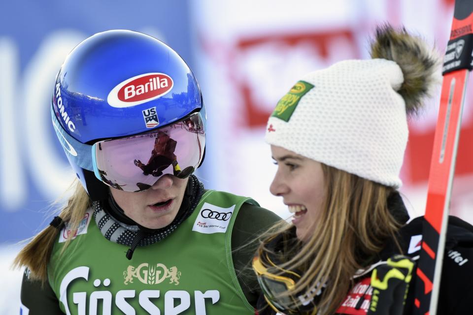 United States' Mikaela Shiffrin, left, talks to Austria's Katharina Liensberger at the finish area of an alpine ski, women's World Cup giant slalom, in Lienz, Austria, Saturday, Dec. 28, 2019. (AP Photo/Piermarco Tacca)