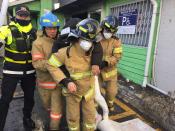 <p>A staff (C) of Miryang hospital is helped by firefighters in front of the damaged hospital after it was burned by a fire in Miryang, South Korea, Jan. 26, 2018. (Photo: Kim Hee-Chul EPA-EFE/REX/Shutterstock) </p>