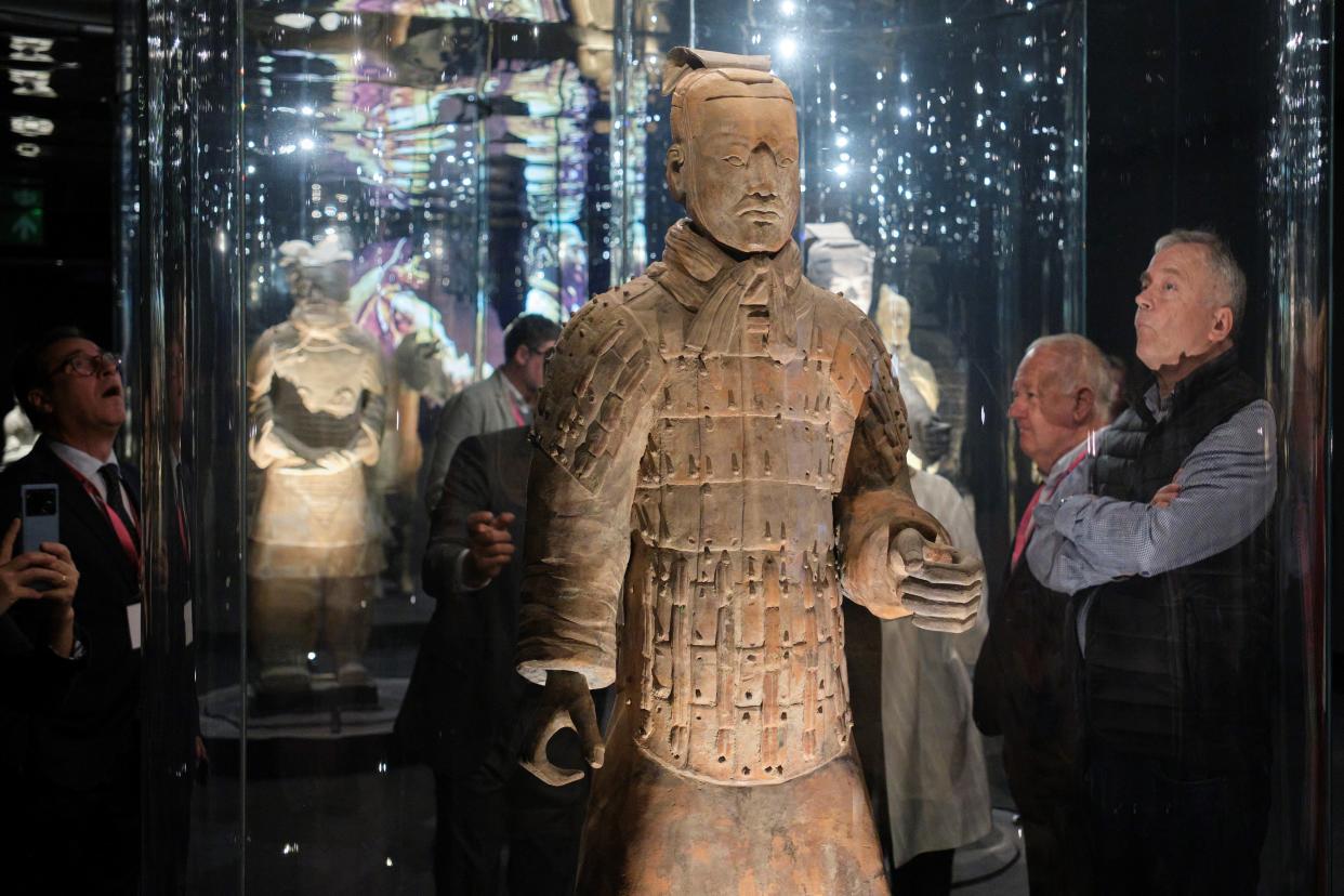 people looking at a terracotta warrior statue