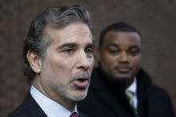 FILE - In this Nov. 19, 2014, file photo, co-lead players' lawyer Christopher Seeger, left, speaks with members of the media after a hearing on the proposed NFL concussion settlement outside of the U.S. Courthouse in Philadelphia. Lawyers for the NFL and retired players filed proposed changes to the $1 billion concussion settlement on Wednesday, Oct. 20, 2021, to remove race-norming in dementia testing, which made it more difficult for Black players to qualify for payments. (AP Photo/Matt Rourke, File)