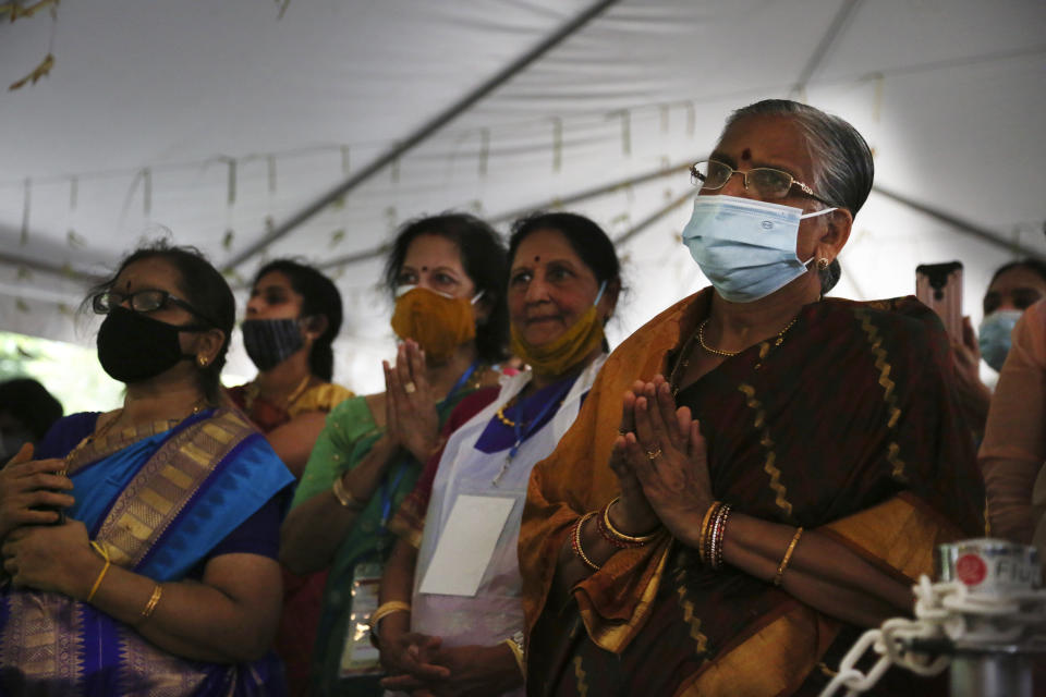 Devotees watch the Maha Kumbhabhishekam rituals on the third day of the Hindu rededication ceremony, Friday, June 25, 2021, at the Sri Venkateswara Temple in Penn Hills, Pa. (AP Photo/Jessie Wardarski)