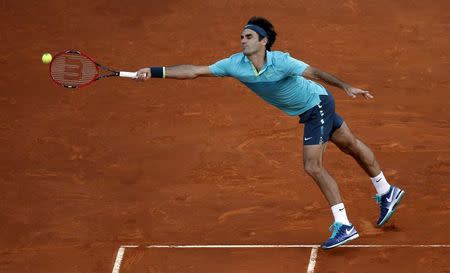 Roger Federer of Switzerland fails to return the ball to Nick Kyrgios of Australia during their match at the Madrid Open tennis tournament in Madrid, Spain, May 6, 2015. REUTERS/Susana Vera