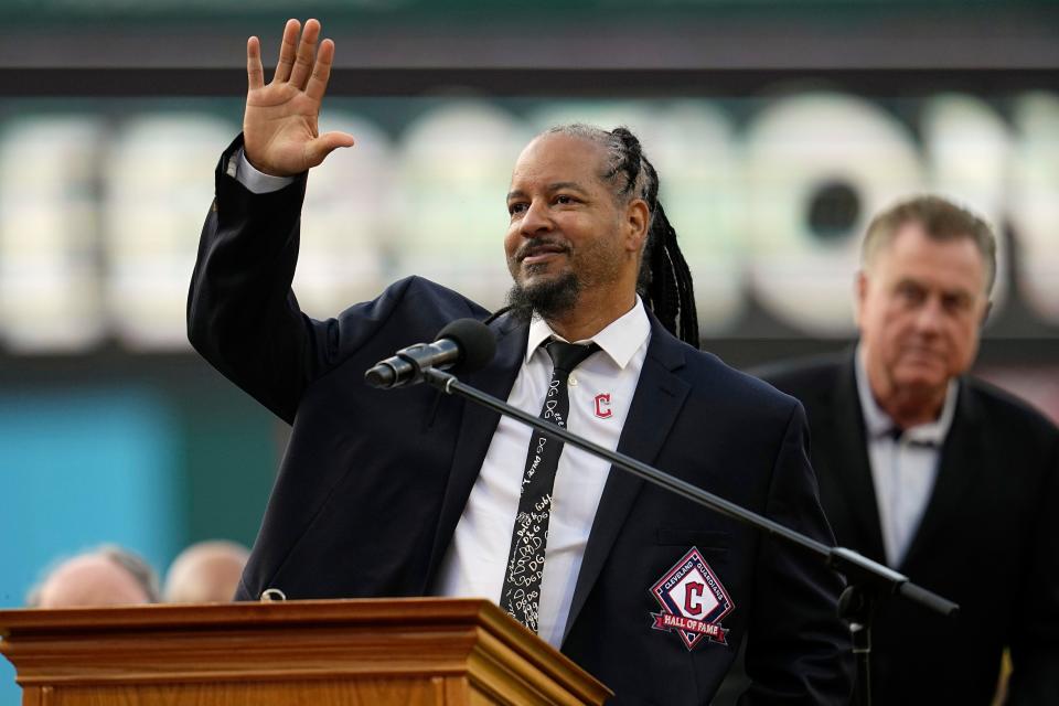 Former Cleveland baseball player Manny Ramirez waves to the crowd during induction ceremonies into the Cleveland Guardians Hall of Game before a game against the Detroit Tigers on Aug. 19, 2023, in Cleveland.