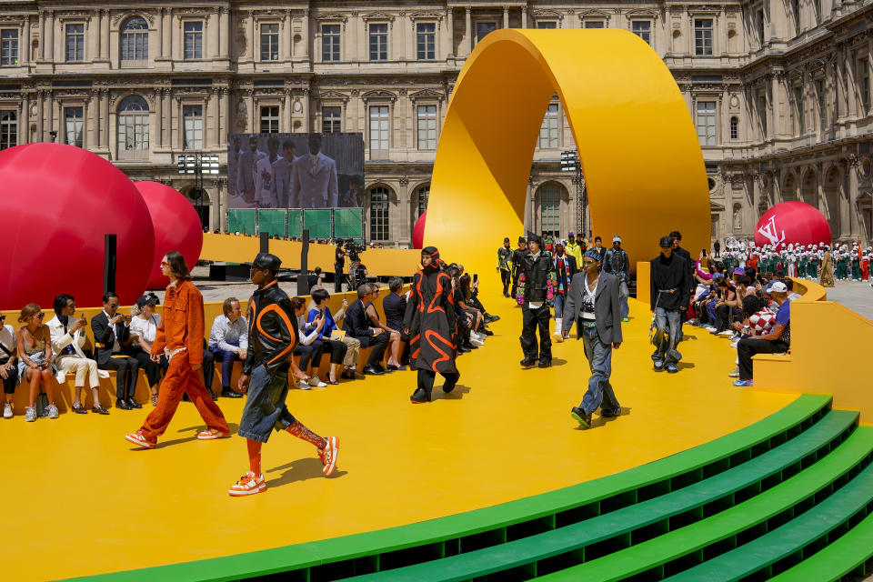 CORRECTS DATE Models wear creations as part of the Louis Vuitton men's Spring Summer 2023 collection presented in Paris, France, Thursday, June 23, 2022. (AP Photo/Francois Mori)