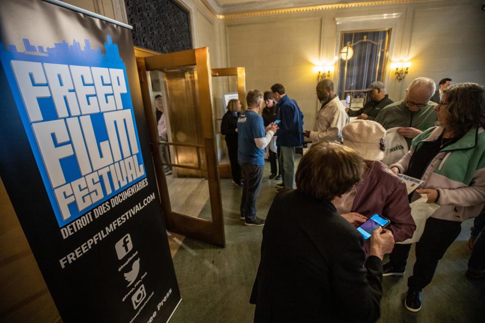 Detroit Film Festival attendees get their passes scanned at the premiere of "Rouge," on the opening night of the annual festival at the Detroit Film Theatre inside the Detroit Institute of Arts on Wednesday, April 10, 2024.