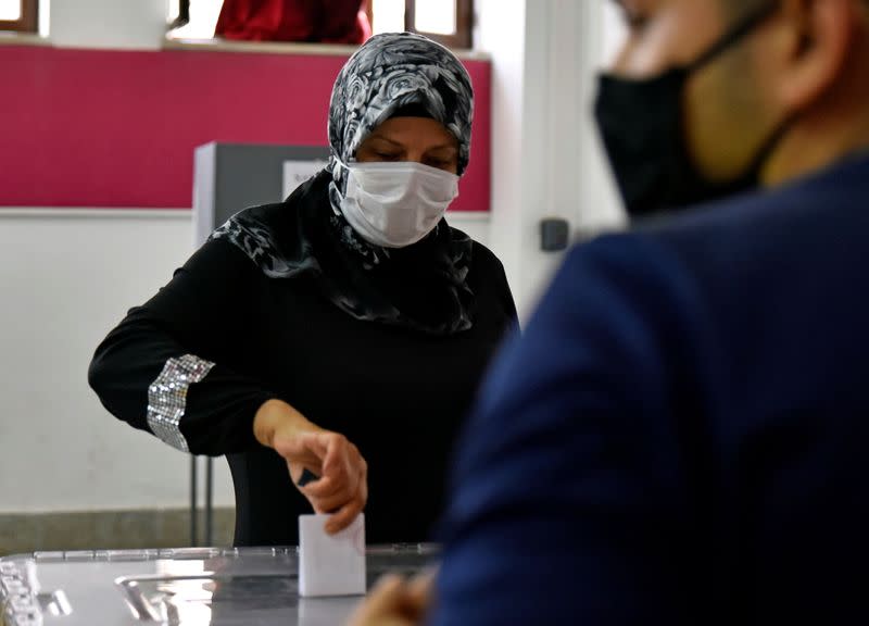 A woman casts her vote at a polling station during Turkish Cypriot presidential election in northern Nicosia