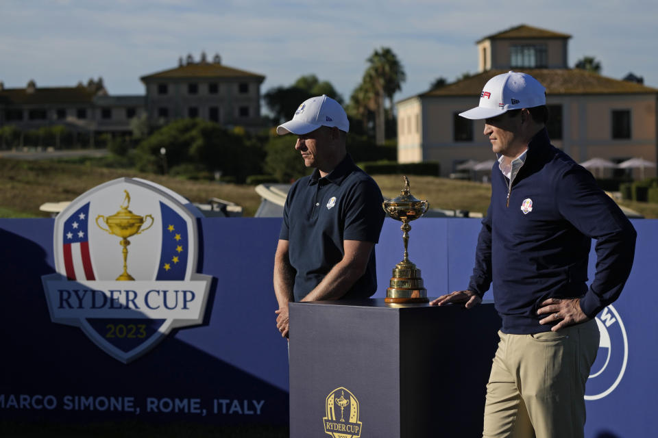 European Captain Luke Donald, left, and United States Captain Zach Johnson pose with the Ryder Cup trophy before an exhibition match on the occasion of The Year to Go event at the Marco Simone course that will host the 2023 Ryder Cup, in Guidonia Montecelio, near Rome, Italy, Monday, Oct. 3, 2022. (AP Photo/Alessandra Tarantino)