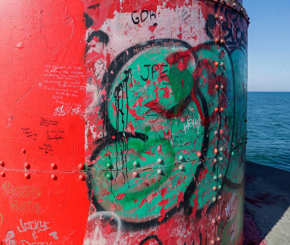 A fresh coat of paint runs into graffiti on the south east side of the Sheboygan Breakwater Lighthouse Oct. 3.
