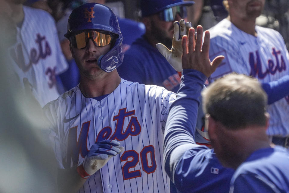 New York Mets Pete Alonso, left, high-five as he returns to the dugout after his fifth inning home run during a baseball game against San Diego Padres, Wednesday, April 12, 2023, in New York. (AP Photo/Bebeto Matthews)