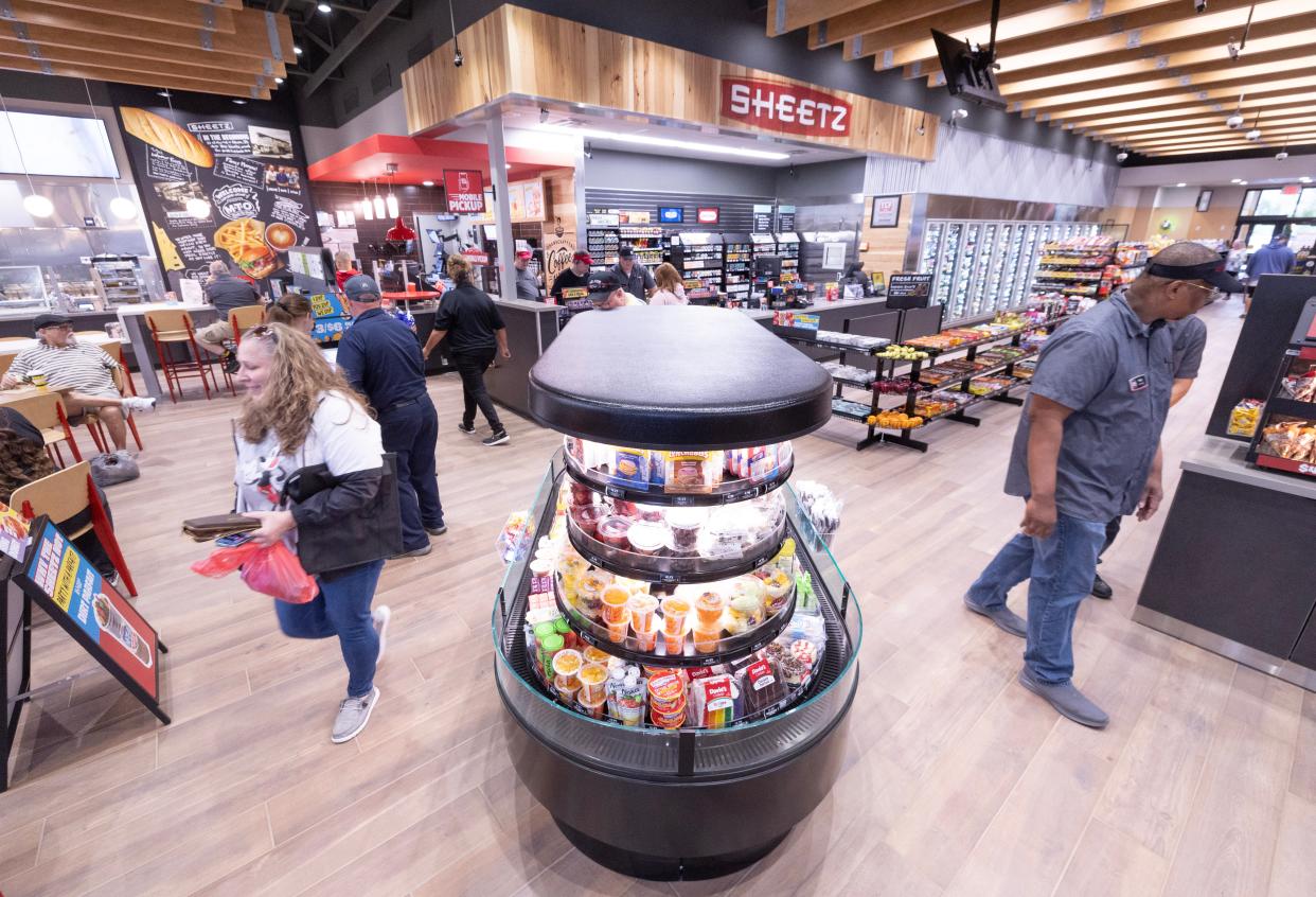 Customers roam the new Sheetz store in Perry Township at its grand opening in May.