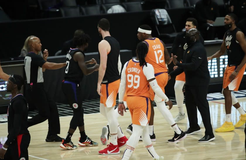 LOS ANGELES, CA - JUNE 30, 202: LA Clippers guard Patrick Beverley (21) proceeds to such Phoenix Suns guard Chris Paul.