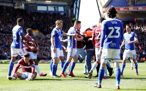A fan is restrained by a steward and players after invading the pitch and attacking Aston Villa's Jack Grealish during the match  - Credit: &nbsp;Action Images via Reuters