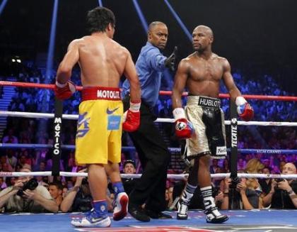 Manny Pacquiao and Floyd Mayweather Jr. stare each other down at the conclusion of a round on May 2. (Reuters)