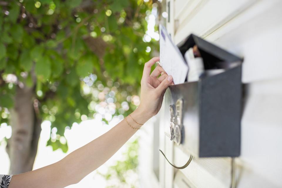 close view of arm reaching for mail